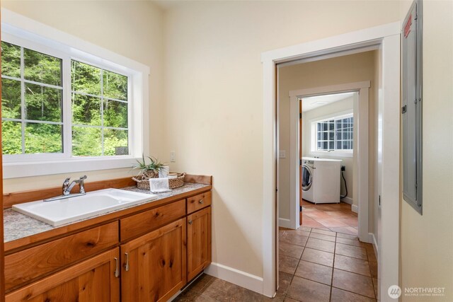 893 Snow Creek Rd, Quilcene, WA 98376 - bathroom featuring washer / dryer, plenty of natural light, and baseboards