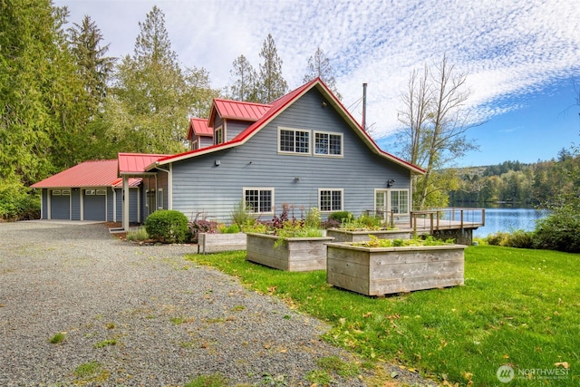 893 Snow Creek Rd, Quilcene, WA 98376 - back of property featuring a lawn, metal roof, a garage, driveway, and a water view