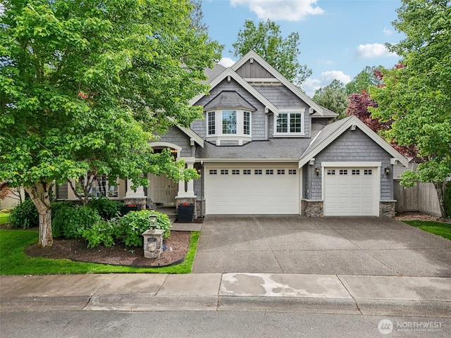 2947 275th Ave SE, Sammamish, WA 98075 - craftsman-style home featuring stone siding, concrete driveway, and a garage