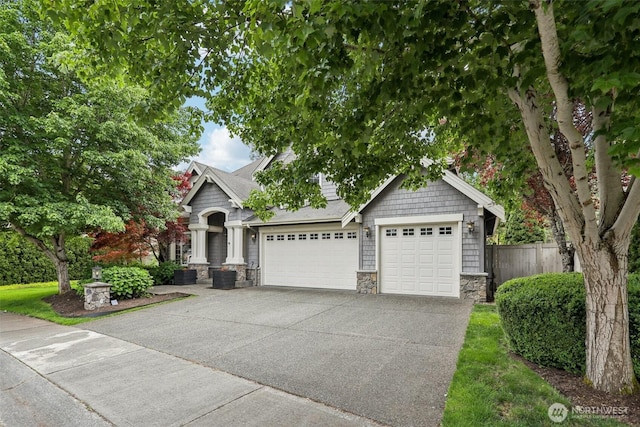 2947 275th Ave SE, Sammamish, WA 98075 - view of front of house featuring stone siding, concrete driveway, a garage, and a shingled roof