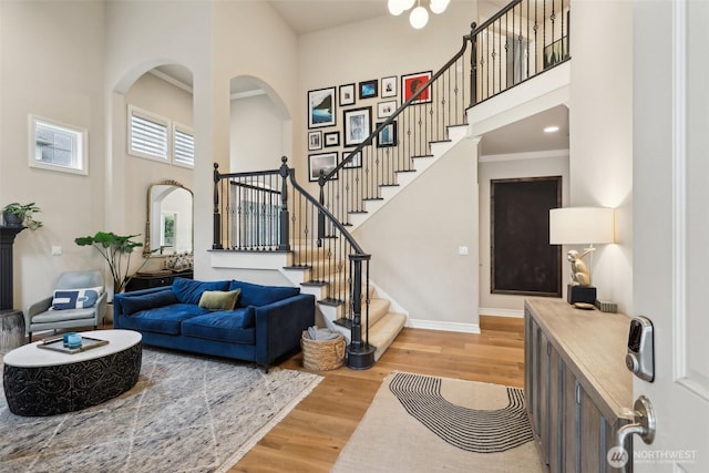 2947 275th Ave SE, Sammamish, WA 98075 - living room featuring a towering ceiling, wood finished floors, stairs, baseboards, and arched walkways