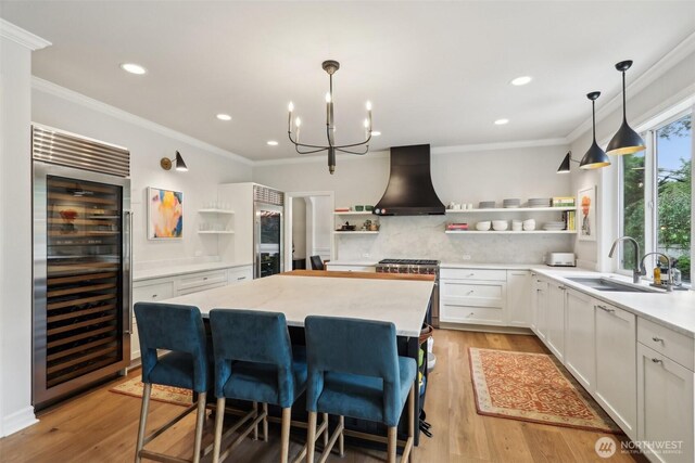 2947 275th Ave SE, Sammamish, WA 98075 - kitchen with open shelves, premium range hood, wine cooler, a sink, and high end stainless steel range oven