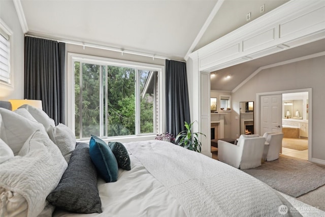 2947 275th Ave SE, Sammamish, WA 98075 - bedroom featuring vaulted ceiling, a lit fireplace, crown molding, and ensuite bath