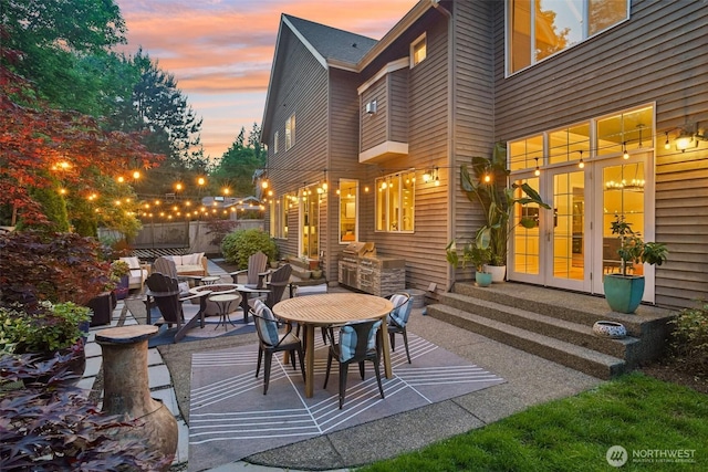 2947 275th Ave SE, Sammamish, WA 98075 - patio terrace at dusk with french doors, a patio, and outdoor dining area