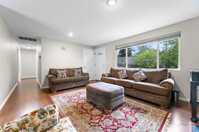 living area with wood finished floors, baseboards, and recessed lighting