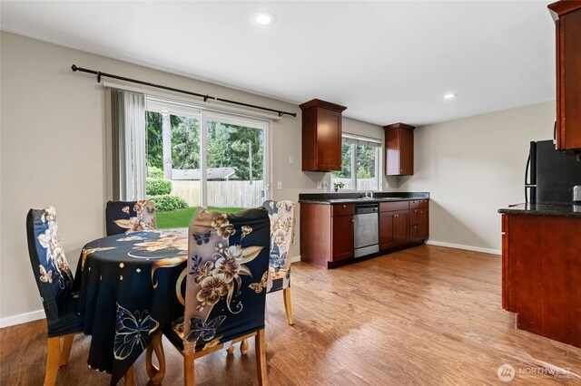 kitchen featuring freestanding refrigerator, dishwasher, baseboards, light wood-style floors, and recessed lighting