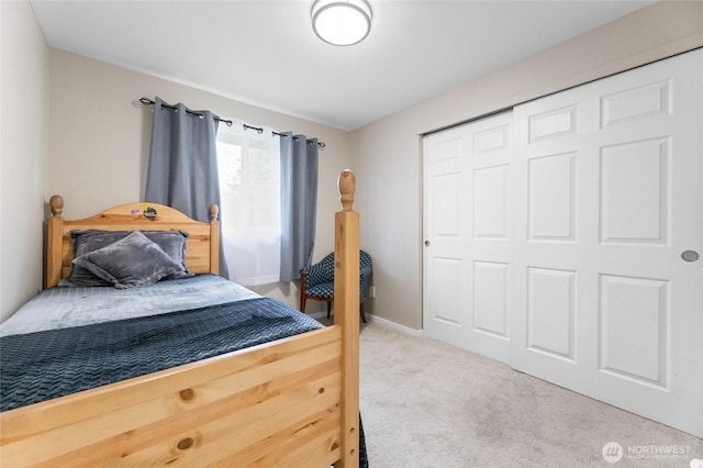 bedroom with carpet floors, a closet, and baseboards