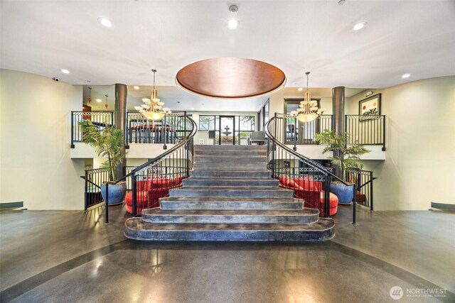 323 Queen Anne Ave N Unit 502, Seattle, WA 98109 - stairway featuring a chandelier, concrete flooring, and recessed lighting