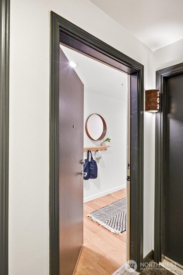 323 Queen Anne Ave N Unit 502, Seattle, WA 98109 - corridor with wood finished floors and baseboards