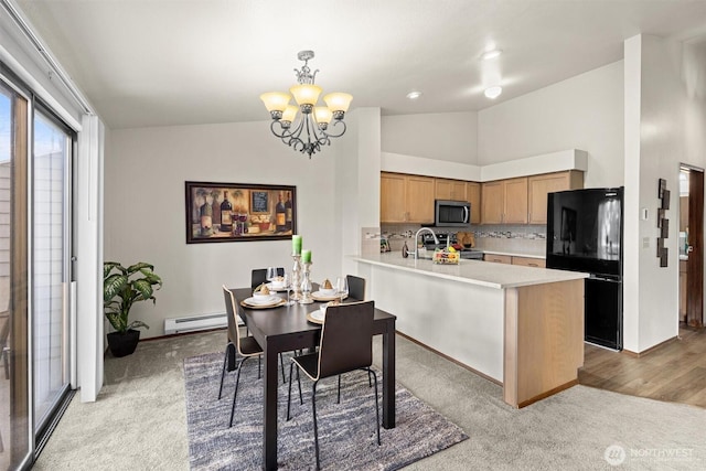 dining room featuring light carpet, vaulted ceiling, a chandelier, baseboards, and a baseboard radiator
