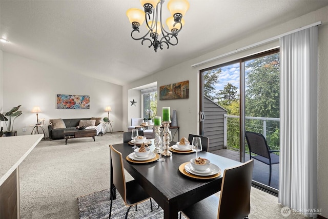dining space with light colored carpet, a chandelier, and lofted ceiling