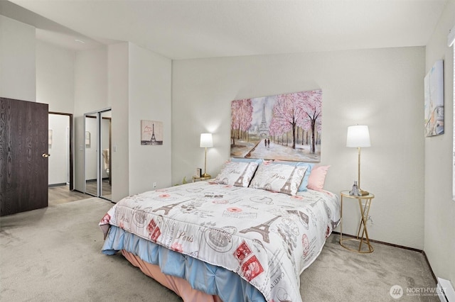 bedroom with carpet floors, a closet, baseboards, and baseboard heating