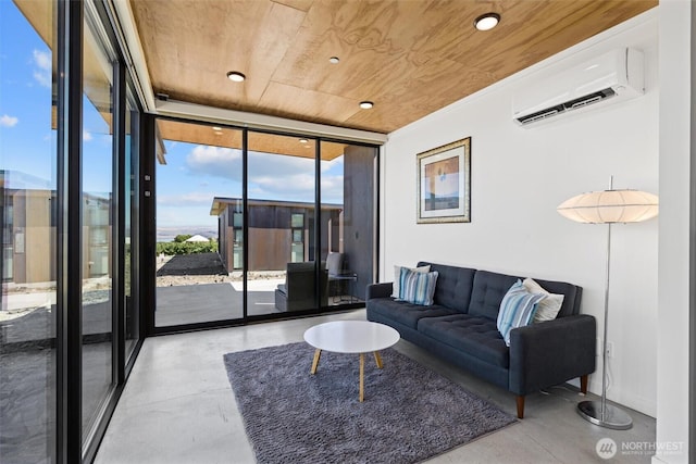 23648 NW Cliffe Pointe Rd Unit 10B, Quincy, WA 98848 - living room featuring wood ceiling, a wall mounted air conditioner, a wall of windows, and concrete floors
