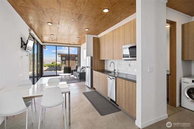 23648 NW Cliffe Pointe Rd Unit 10B, Quincy, WA 98848 - kitchen featuring modern cabinets, appliances with stainless steel finishes, washer / dryer, a sink, and wooden ceiling