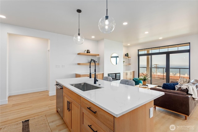 312 N State St Unit 101, Bellingham, WA 98225 - kitchen featuring a sink, open floor plan, open shelves, stainless steel dishwasher, and light wood-style floors