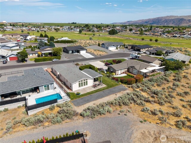 406 Apricot Pl SW, Mattawa, WA 99349 - aerial perspective of suburban area with a mountainous background and a pool area