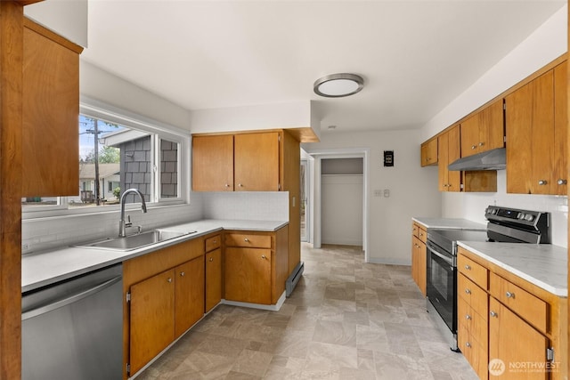 17291725 5th Ave SE, Olympia, WA 98501 - kitchen featuring stainless steel appliances, under cabinet range hood, a sink, and tasteful backsplash