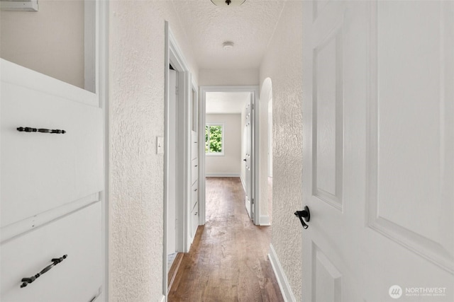 17291725 5th Ave SE, Olympia, WA 98501 - hall with wood finished floors, a textured wall, a textured ceiling, and baseboards
