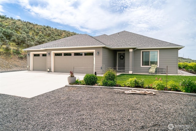 11975 NE Neppel Rd, Moses Lake, WA 98837 - view of front of home with a garage, concrete driveway, and roof with shingles