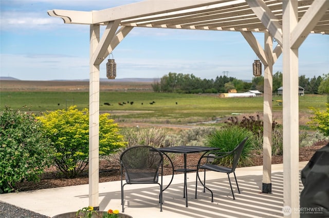 11975 NE Neppel Rd, Moses Lake, WA 98837 - view of patio featuring a pergola and a rural view