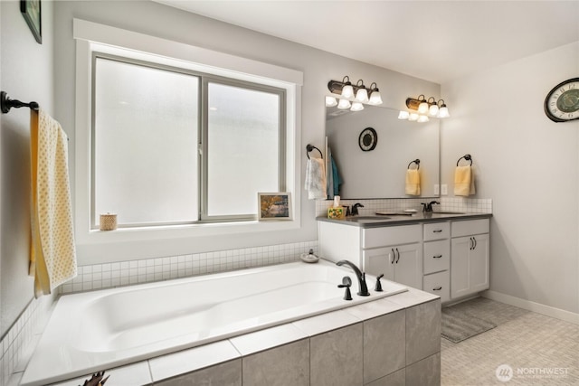 11975 NE Neppel Rd, Moses Lake, WA 98837 - bathroom featuring double vanity, a bath, backsplash, and baseboards