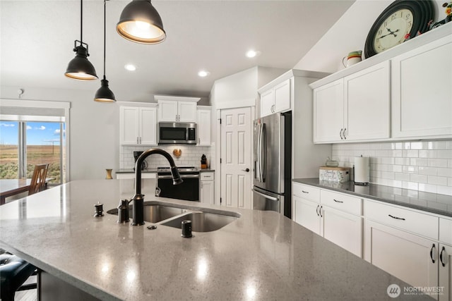 11975 NE Neppel Rd, Moses Lake, WA 98837 - kitchen featuring stainless steel appliances, a sink, white cabinets, decorative backsplash, and hanging light fixtures