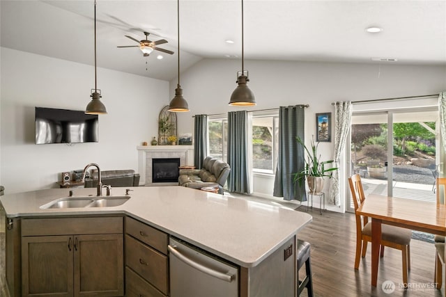 11975 NE Neppel Rd, Moses Lake, WA 98837 - kitchen with a sink, lofted ceiling, a ceiling fan, stainless steel dishwasher, and a tiled fireplace