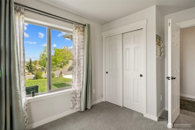 11975 NE Neppel Rd, Moses Lake, WA 98837 - unfurnished bedroom with carpet floors, multiple windows, a closet, and baseboards