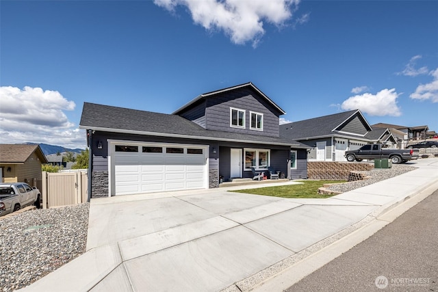 2436 Berkley Loop, East Wenatchee, WA 98802 - view of front of home featuring driveway, an attached garage, covered porch, and stone siding