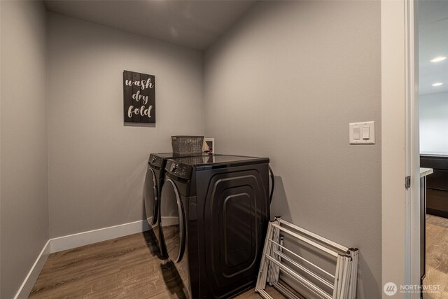 2436 Berkley Loop, East Wenatchee, WA 98802 - laundry area with independent washer and dryer, wood finished floors, baseboards, and recessed lighting