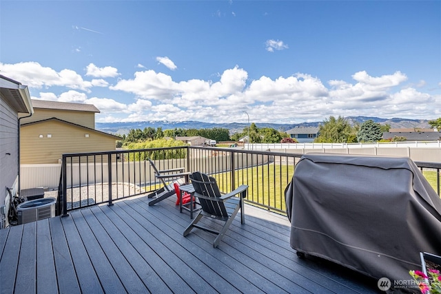 2436 Berkley Loop, East Wenatchee, WA 98802 - wooden deck with a grill, a mountain view, central air condition unit, and a yard