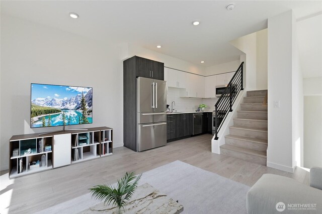 109 22nd Ave E Unit C, Seattle, WA 98112 - living room with stairway, light wood finished floors, recessed lighting, and baseboards