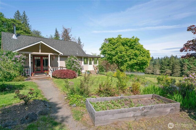 285 Pete Beck Rd, Quilcene, WA 98376 - view of front of home with a vegetable garden, french doors, roof with shingles, and a porch