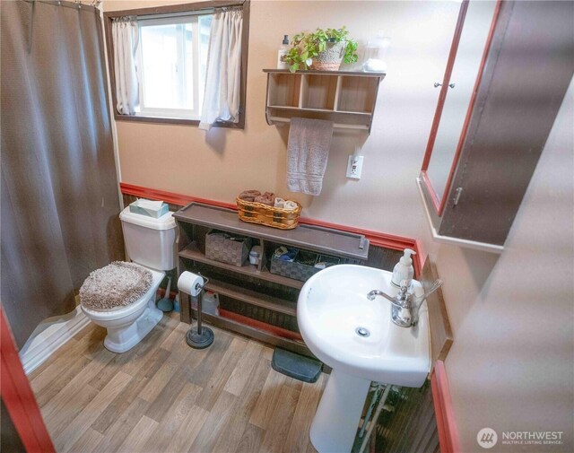 285 Pete Beck Rd, Quilcene, WA 98376 - bathroom with wood finished floors, a shower with curtain, and toilet