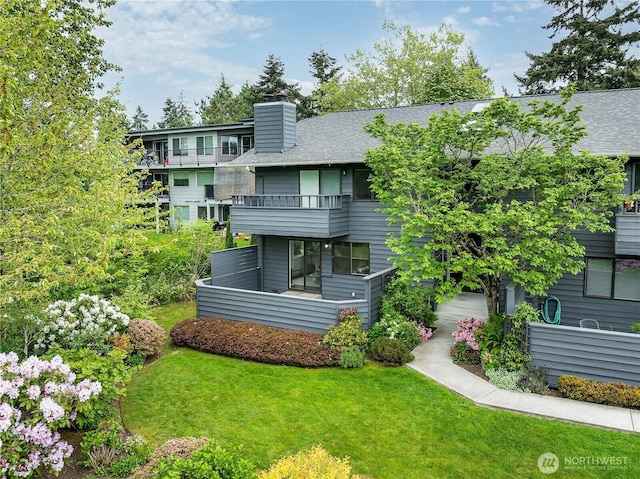 6533 106th Ave NE Unit D, Kirkland, WA 98033 - rear view of house featuring a balcony, a yard, a chimney, and roof with shingles