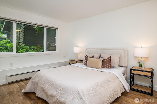 6533 106th Ave NE Unit D, Kirkland, WA 98033 - bedroom with wood finished floors, a baseboard radiator, and baseboards