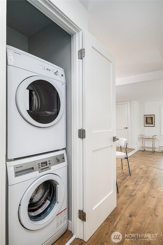 6533 106th Ave NE Unit D, Kirkland, WA 98033 - laundry room featuring stacked washing machine and dryer and wood finished floors