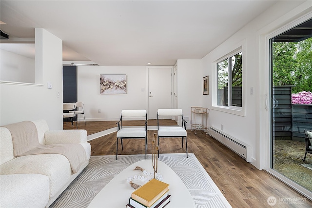6533 106th Ave NE Unit D, Kirkland, WA 98033 - living area featuring baseboard heating, wood finished floors, and baseboards