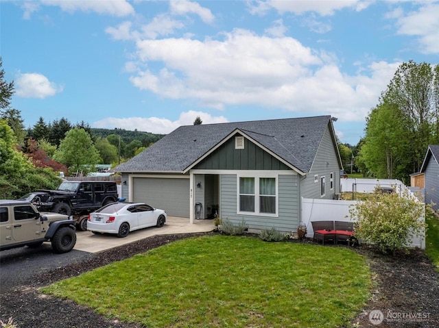 817 B St, Vader, WA 98593 - view of front of house featuring board and batten siding, a garage, concrete driveway, and a shingled roof