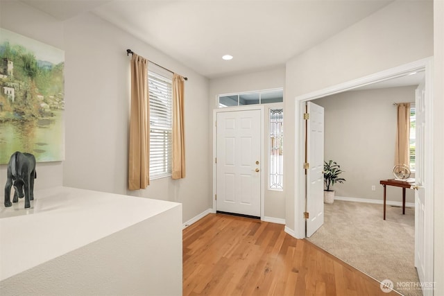 entryway with baseboards, light wood-type flooring, and recessed lighting