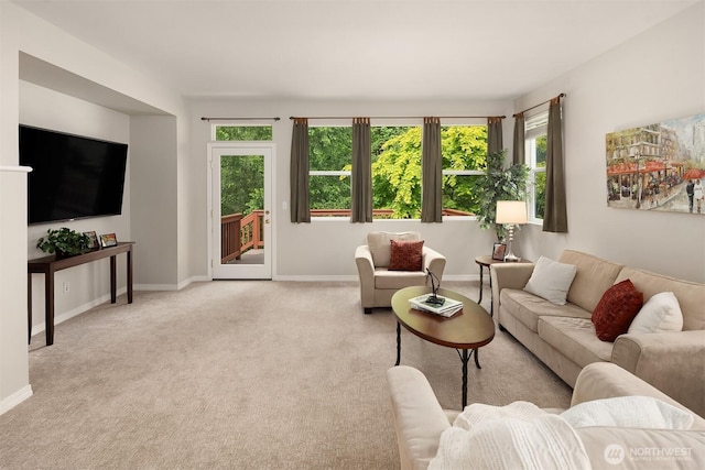 living room with baseboards and carpet