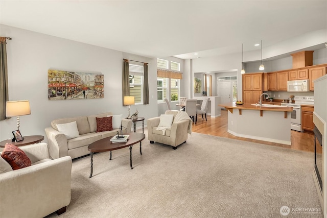 living room featuring light colored carpet and recessed lighting