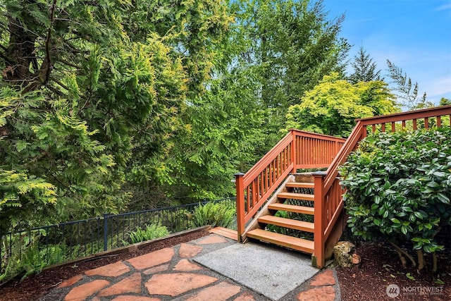 view of patio / terrace featuring stairs, a wooden deck, and fence