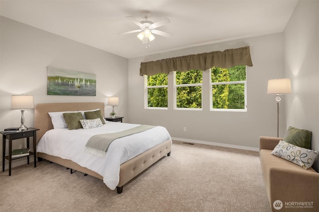 carpeted bedroom featuring baseboards and ceiling fan