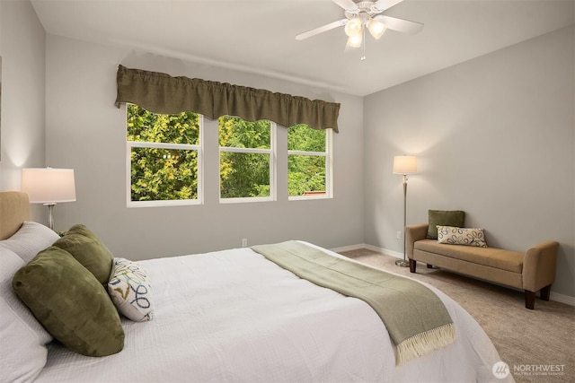 bedroom featuring baseboards, carpet flooring, and a ceiling fan