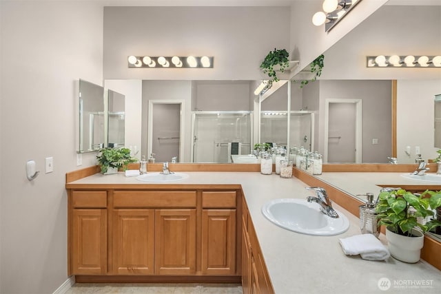 bathroom with a stall shower and double vanity