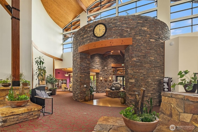 view of exterior entry featuring stucco siding, a patio, and stone siding