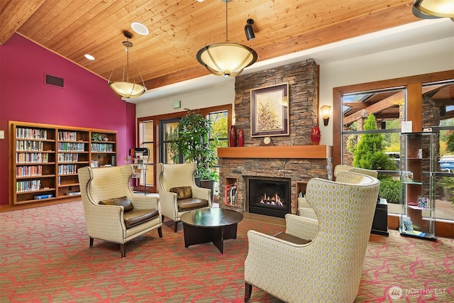 sitting room featuring carpet flooring, wooden ceiling, and a fireplace