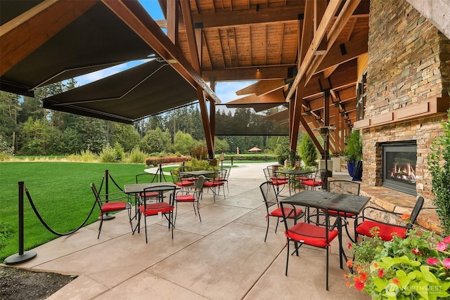 view of patio / terrace with an outdoor stone fireplace and outdoor dining area