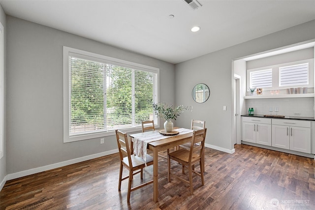 dining room with baseboards, dark wood-style flooring, and recessed lighting